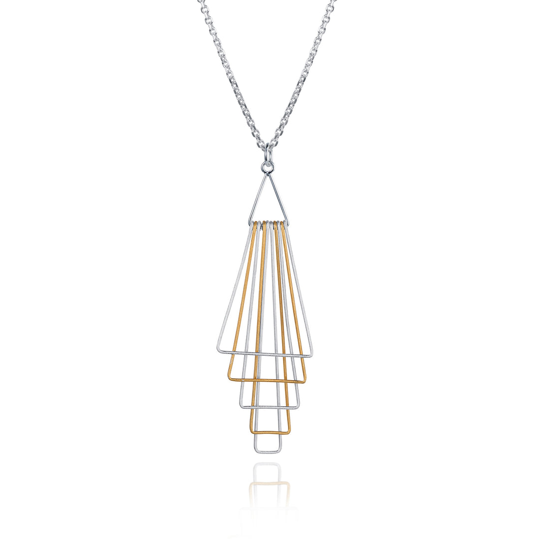Silver and gold geometric pendant on a white background