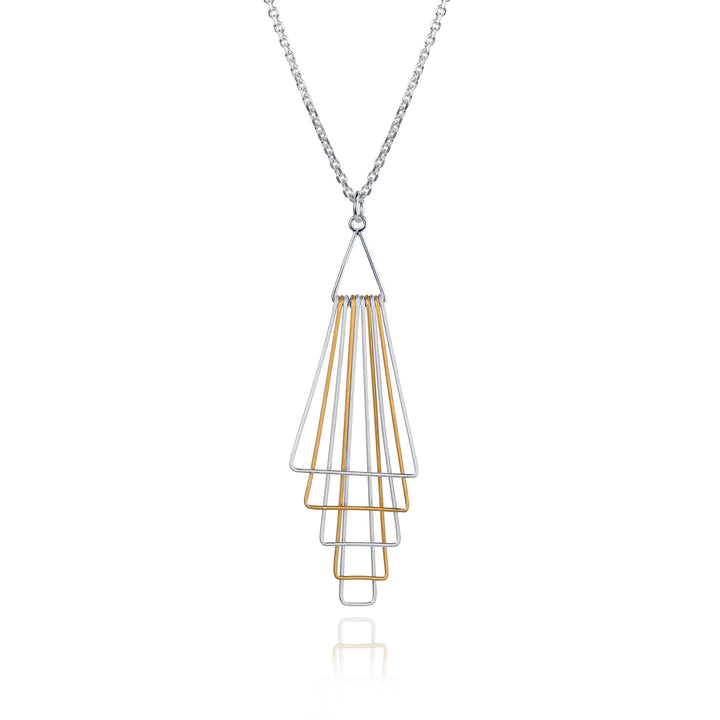 Silver and gold geometric pendant on a white background