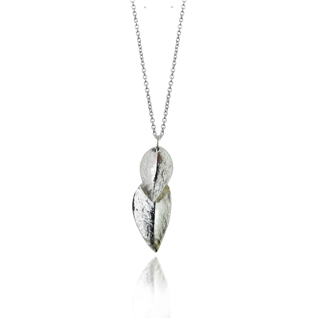Silver leaf-shaped pendant on a chain against a white background