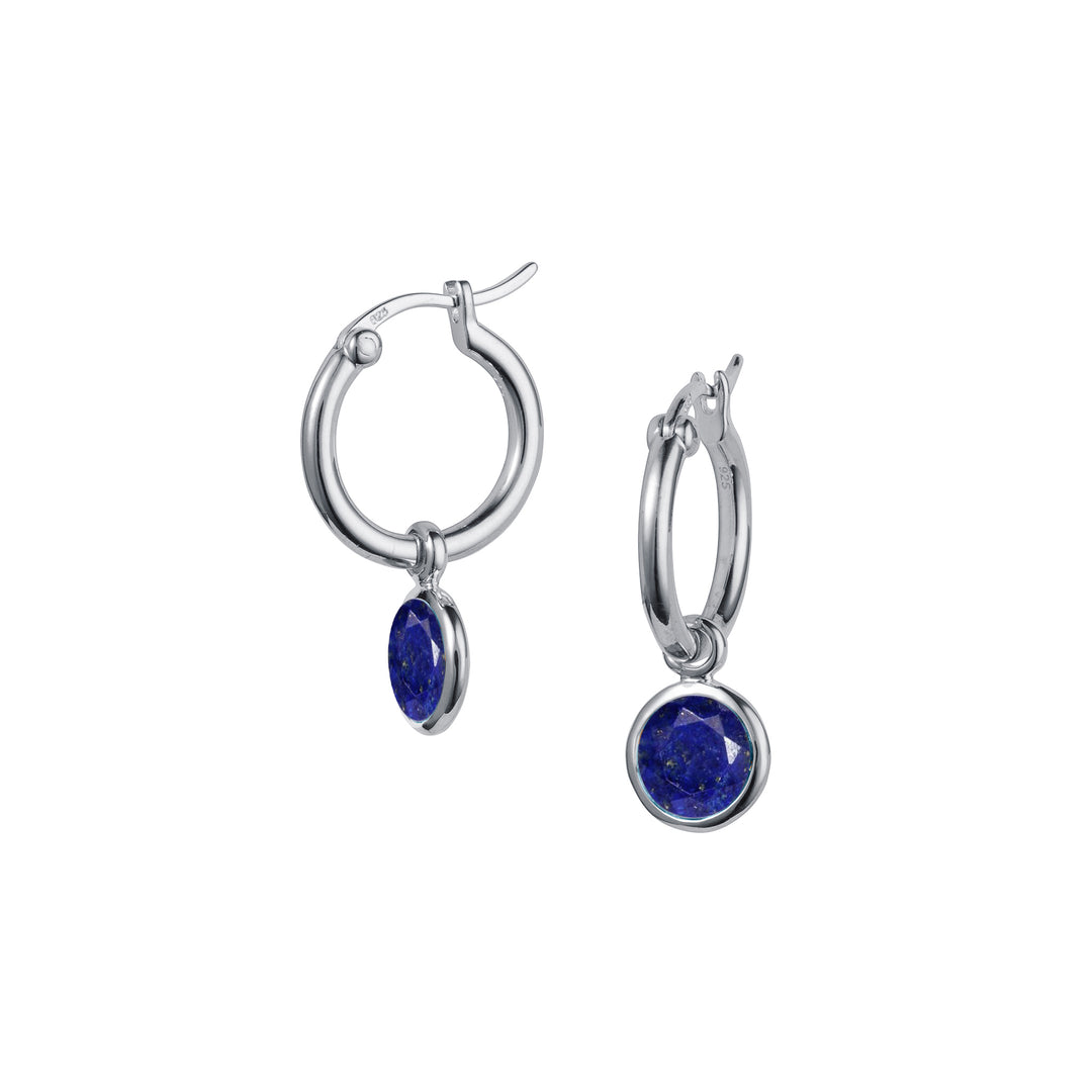 Silver huggie snap post earrings with dark blue lapis lazuli drops on a white background