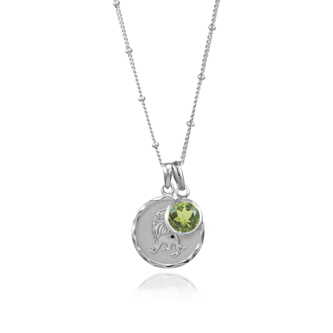 Silver Leo zodiac pendant and peridot August birthstone charm on gray background