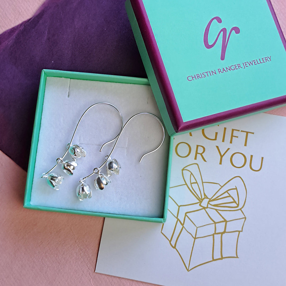 Silver long drop lily of the valley flower earrings in a Christin Ranger Jewellery gift box with tissue and gift card.