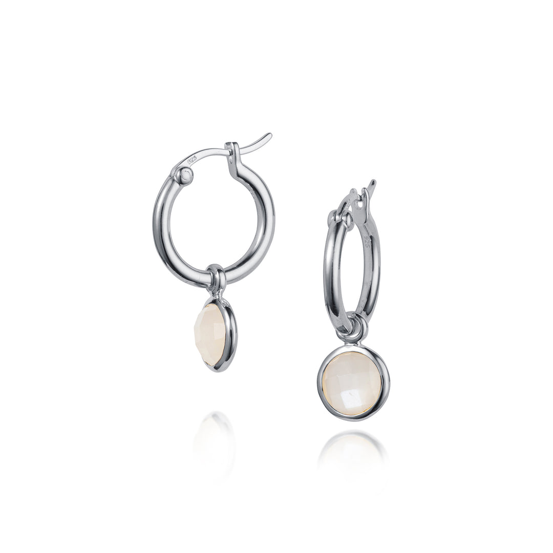 Silver hoop earrings with round white gemstones on a white background