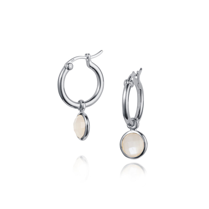 Silver hoop earrings with round white gemstones on a white background