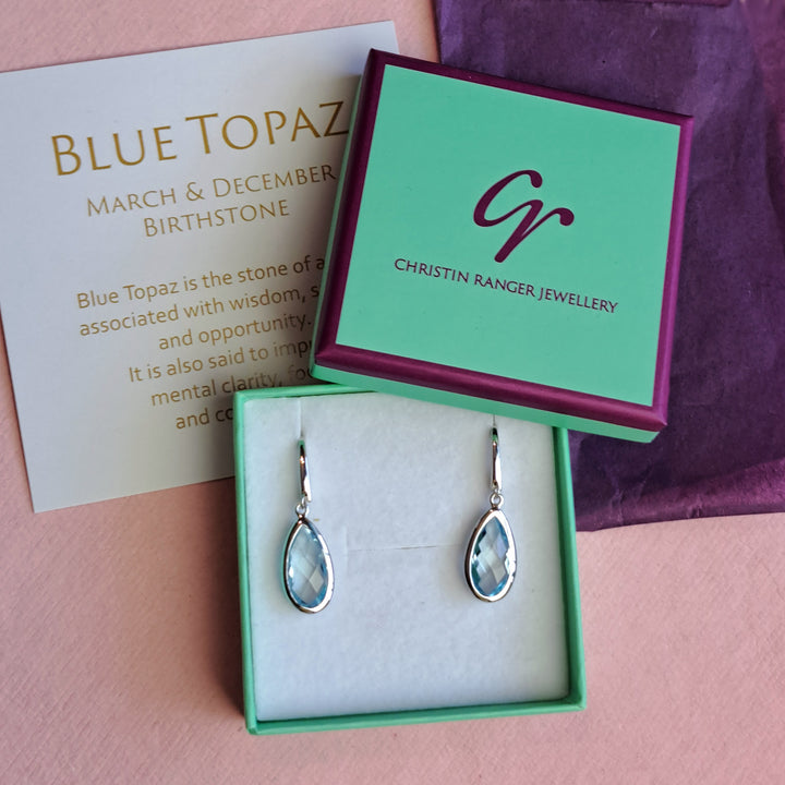Sterling silver pear drop earrings with blue topaz in Christin Ranger Jewellery gift packaging