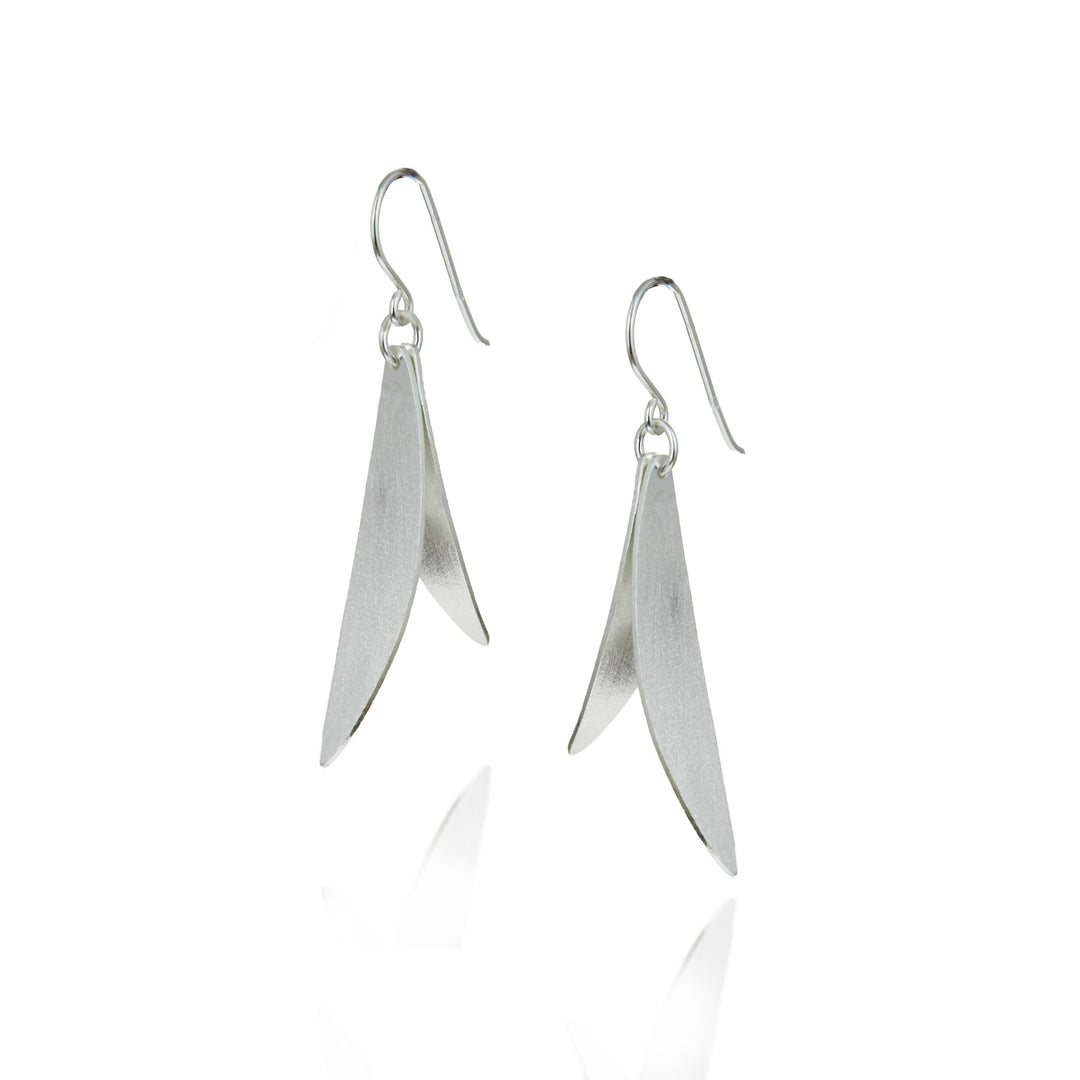 Pair of silver leaf-shaped earrings on a white background