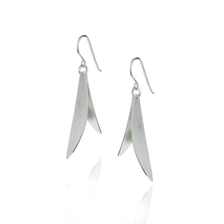 Pair of silver leaf-shaped earrings on a white background