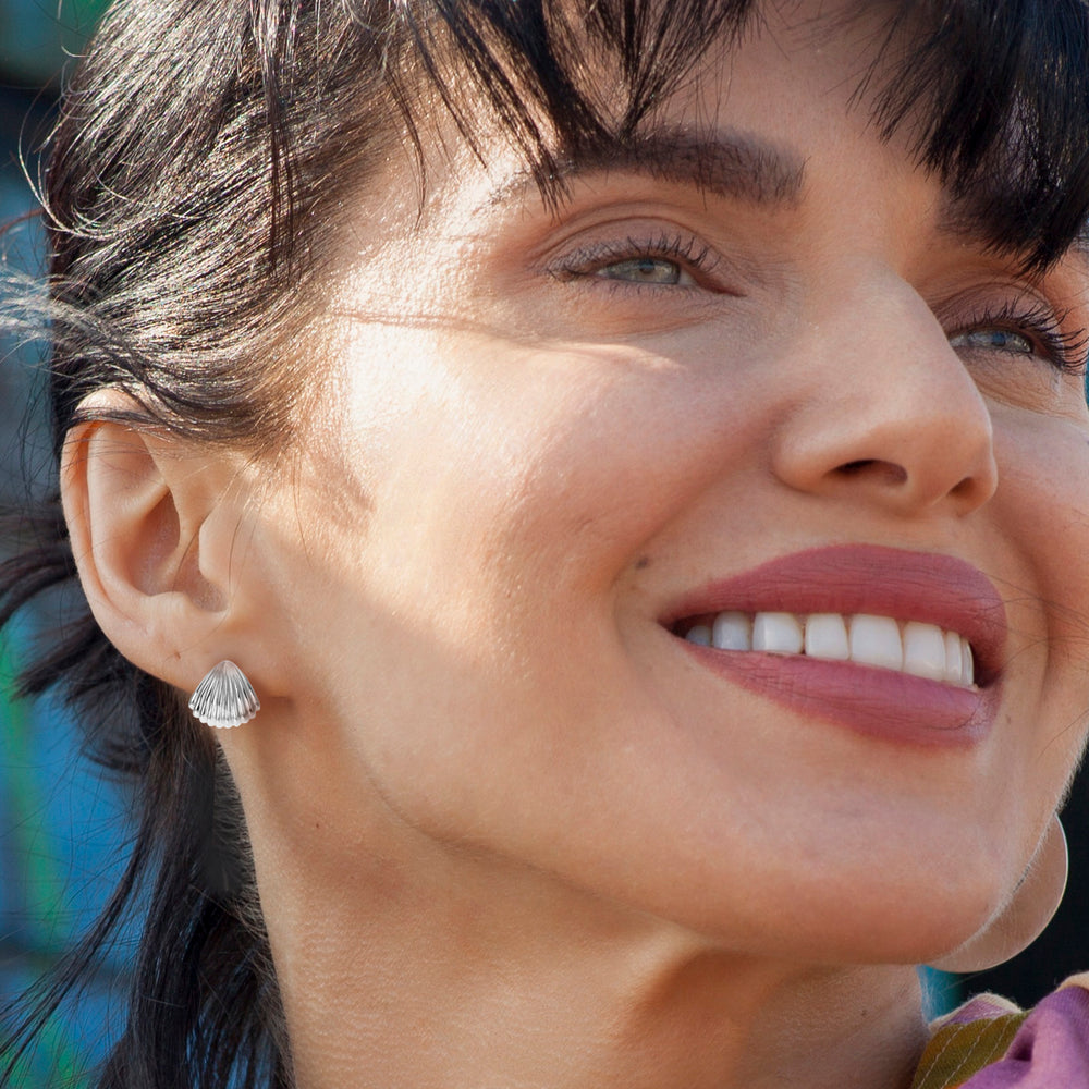 Model wearing sterling silver seashell stud earrings