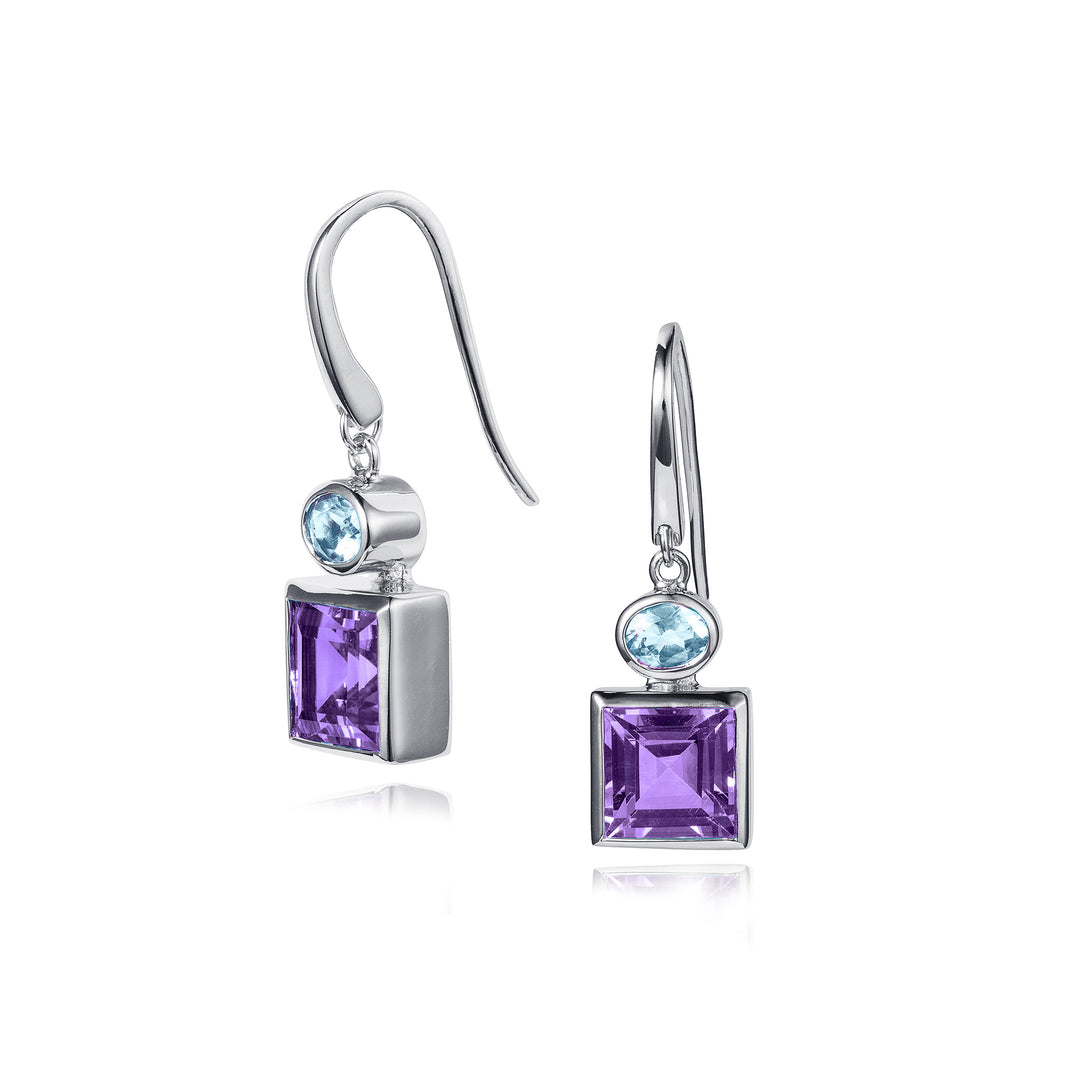 Silver earrings with square purple and oval blue gemstones on a white background