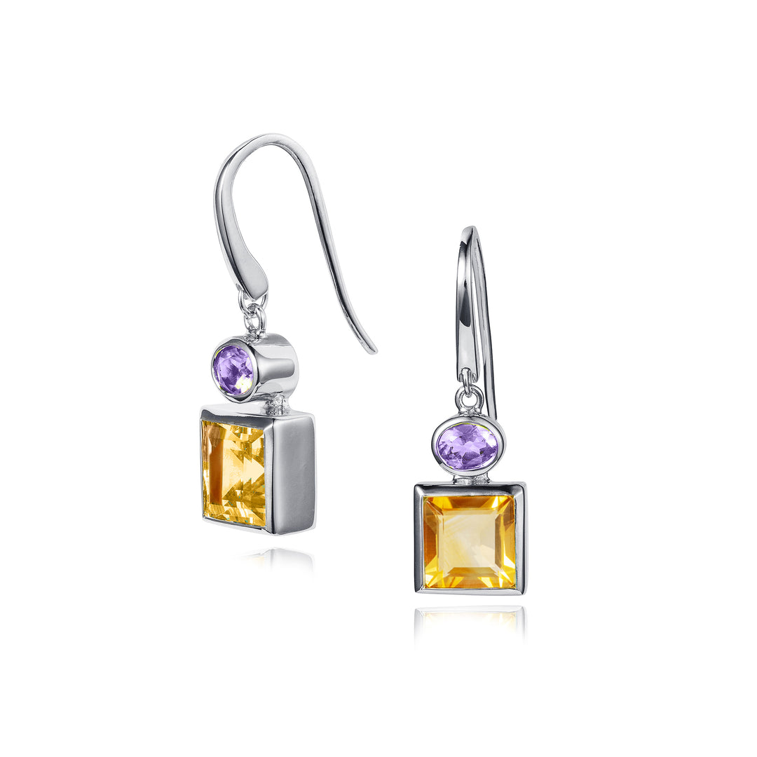 Pair of silver earrings with square-cut yellow gemstones and purple gemstones on a white background