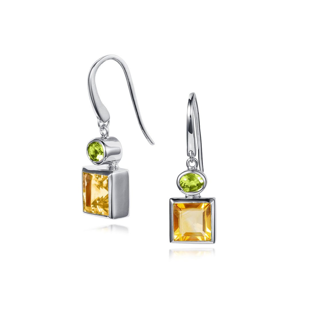 Silver earrings with square citrine and round peridot stones on a white background