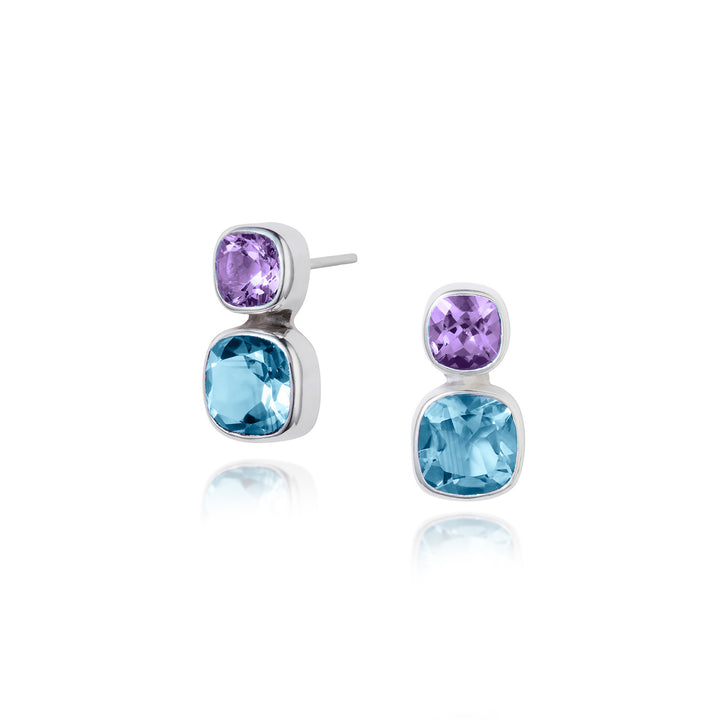 Pair of 
silver stud earrings with blue and amethyst gemstones on a white background