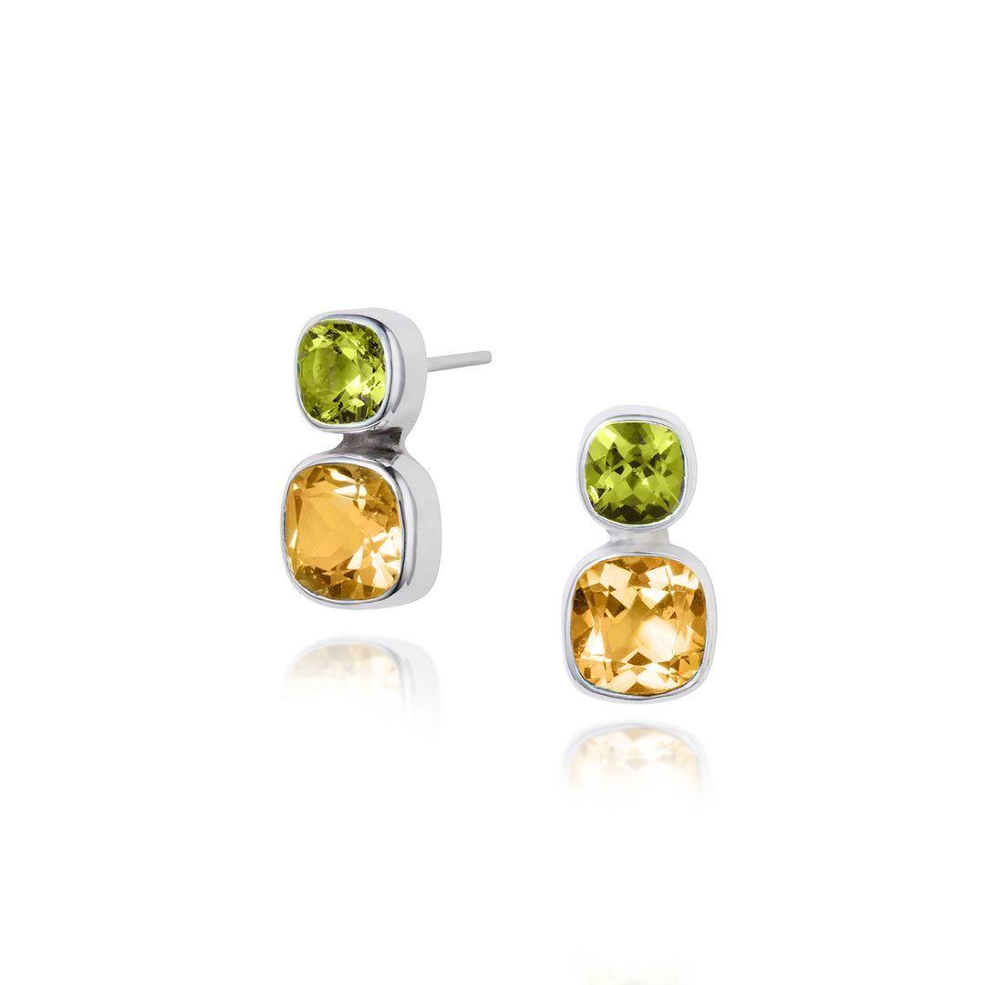 silver stud earrings with cushion cut citrine and peridot gemstones on a white background
