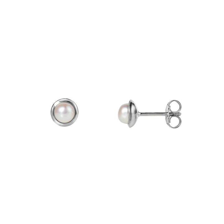 Small round pearl stud earrings in silver on a white background