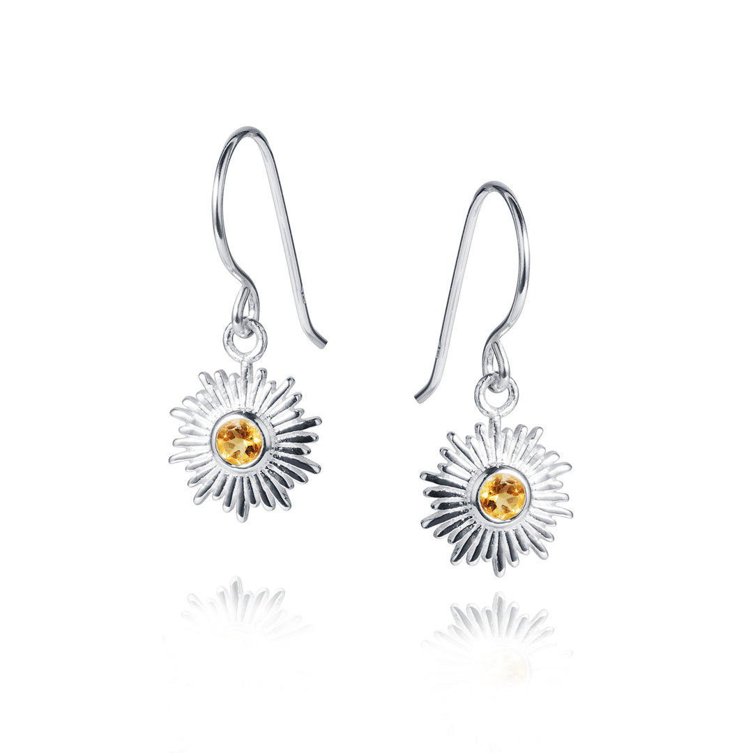 Silver sun earrings with hooks and citrine gemstones on a white background