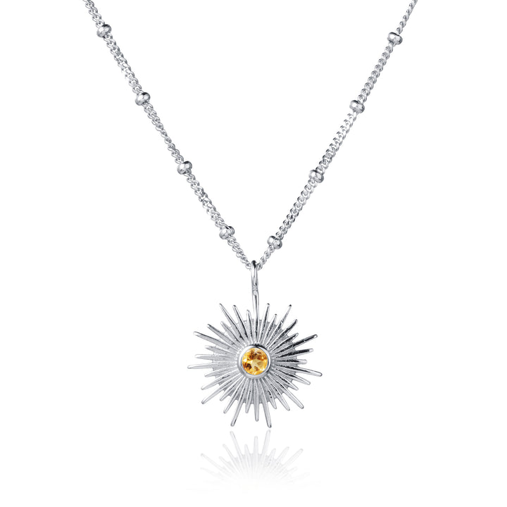 Silver sun necklace with beaded curb chain and set with a citrine gemstone on white background