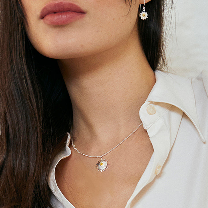 Close-up of model wearing a silver citrine sun set with earrings and necklace