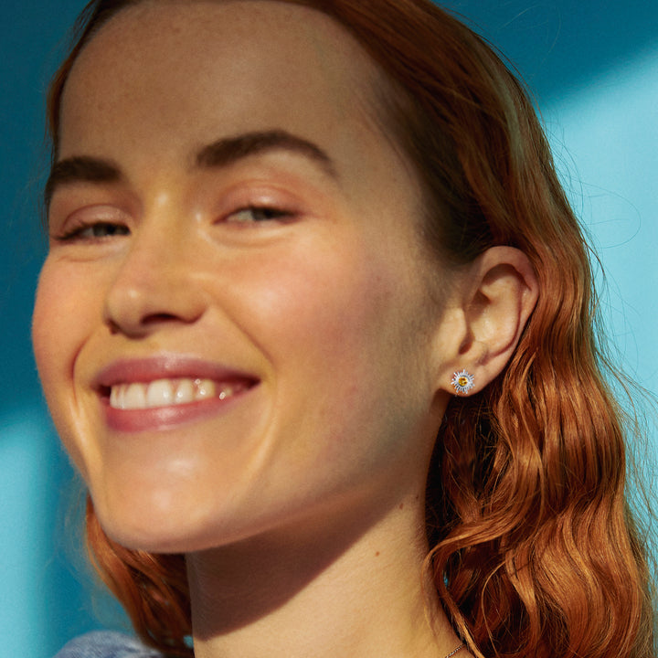 Model wearing a silver sun stud earring with citrine