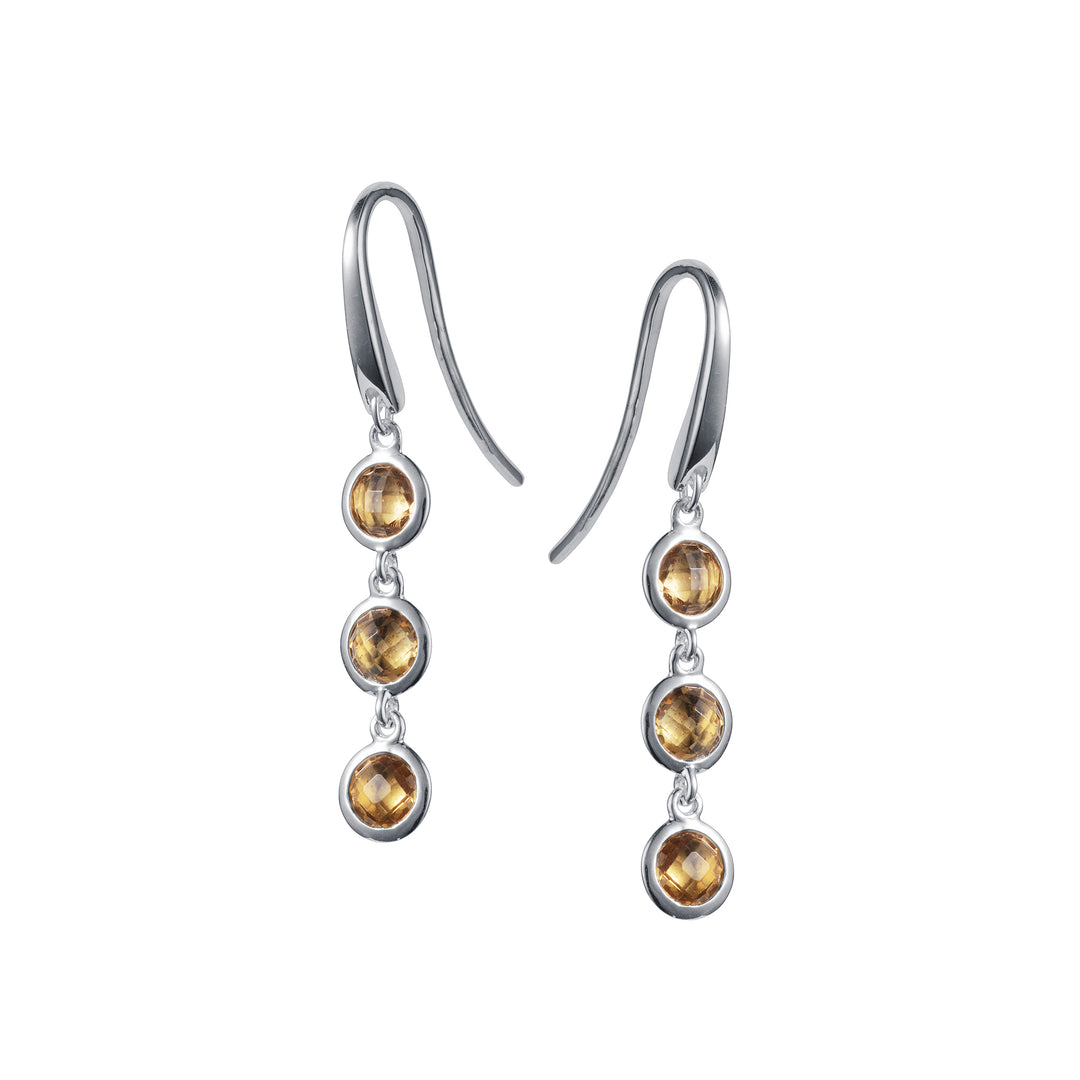 Silver dangle earrings with three smoky quartz gemstones on a white background