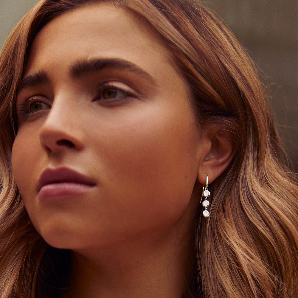 Model wearing silver and moonstone drop earrings
