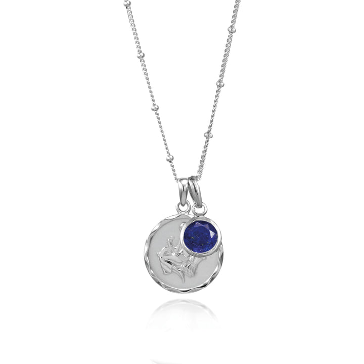 Silver virgo star sign pendant with lapis September birthstone charm on gray background