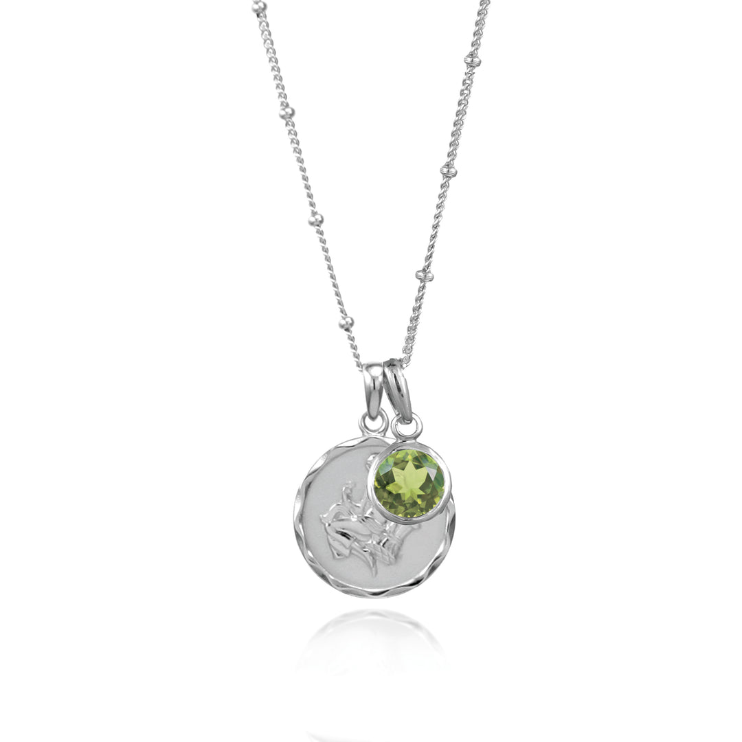Silver virgo star sign pendant with green peridot August birthstone charm on white background