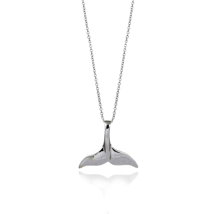 Silver whale tail pendant on a chain against a white background