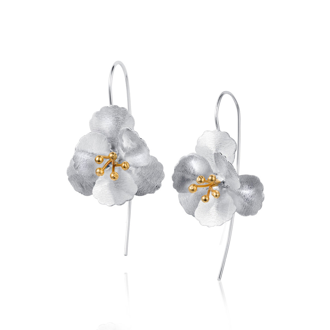 Silver floral earrings with gold accents on a white background