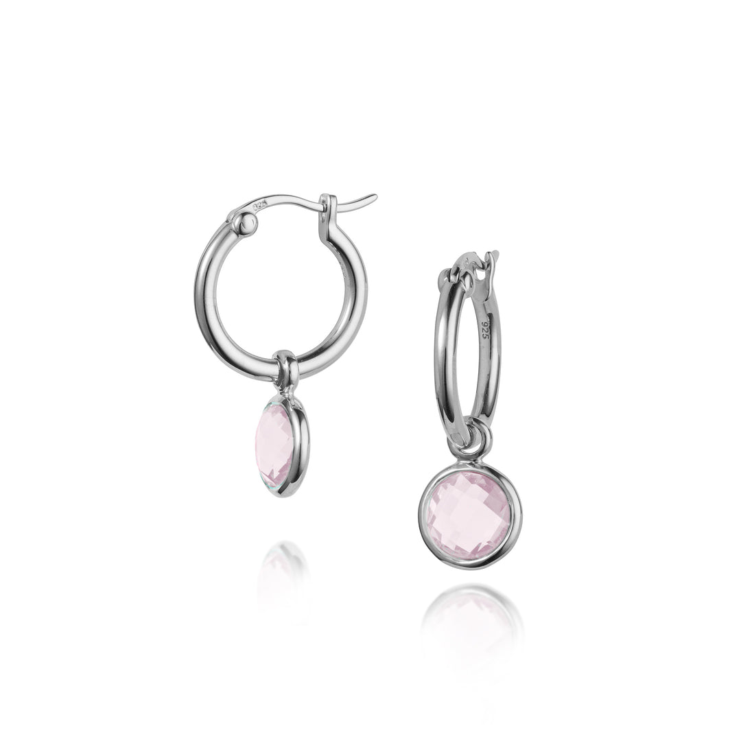 Silver snap-post hoop earrings with pink gemstones on a white background