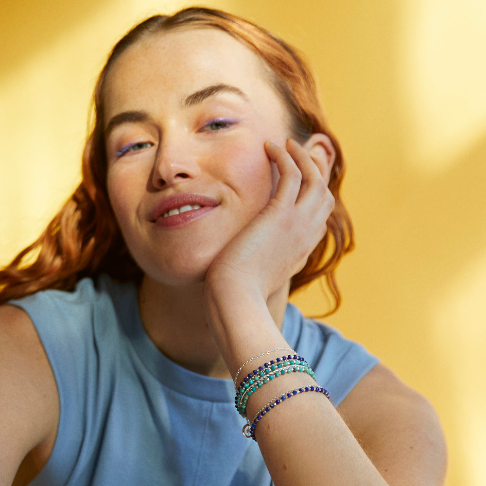 Model wearing sterling silver beaded bracelets with lapis lazuli and turquoise gemstones.