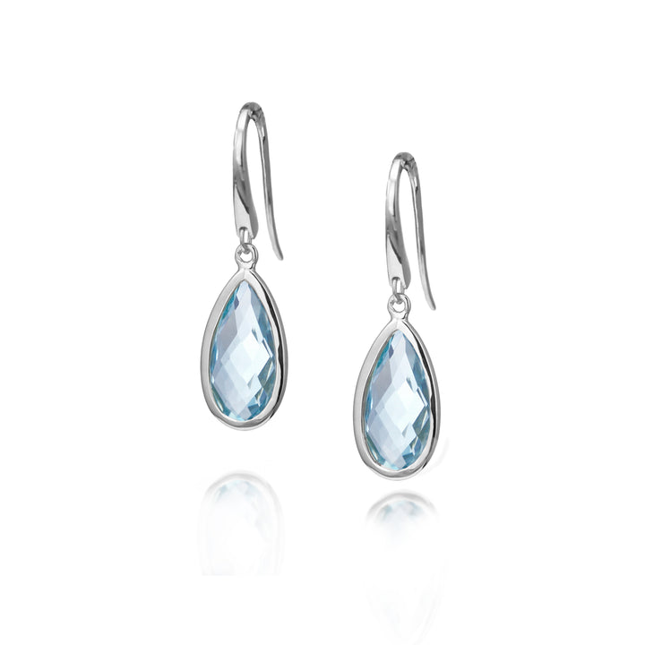 Silver earrings with blue teardrop-shaped gemstones on a white background