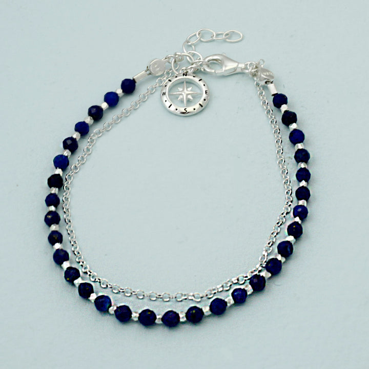 Sterling silver beaded compass bracelet in lapis lazuli on a reflective background