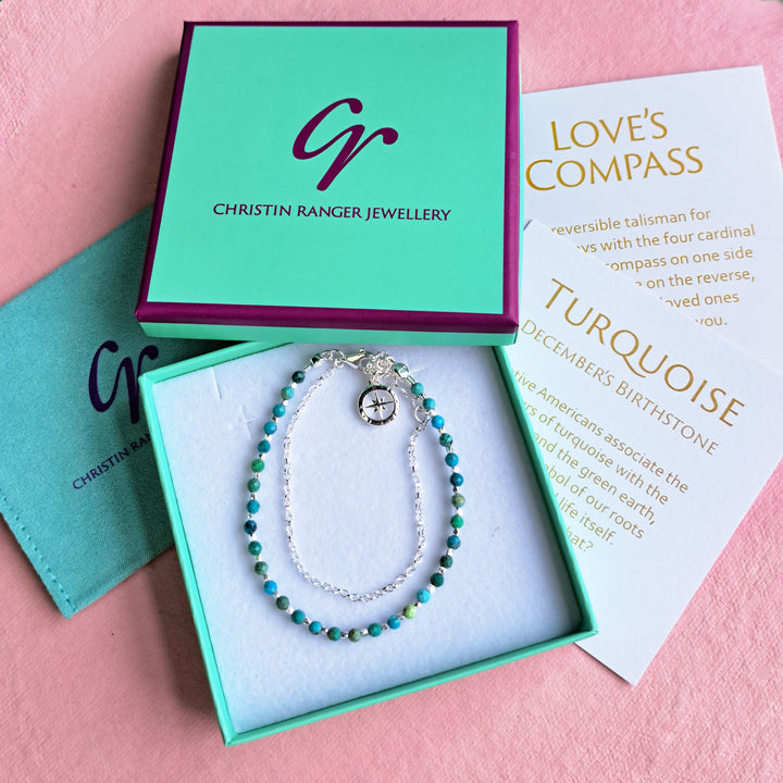 Sterling silver beaded compass bracelet in turquoise on a pink background with gift packaging