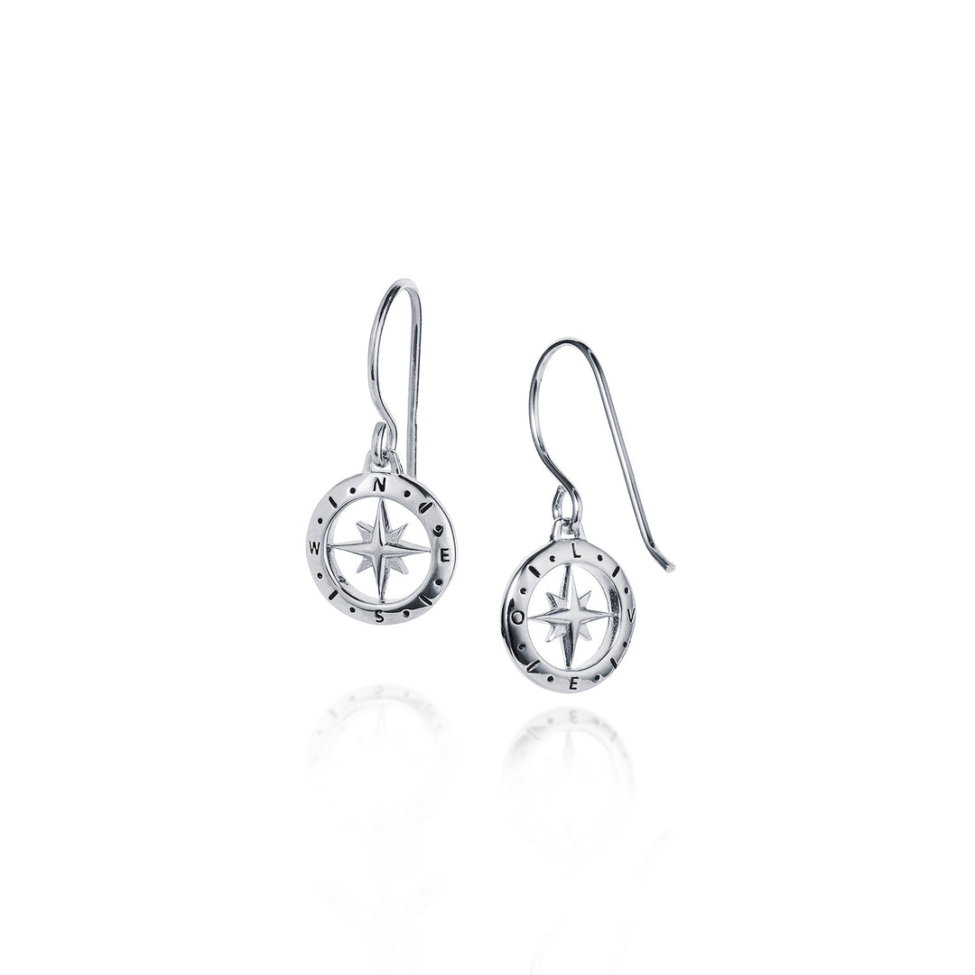Silver earrings with star compass design on a white background