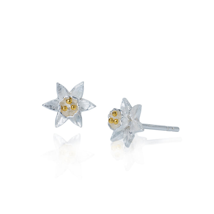 Pair of delicate silver and gold daffodil-shaped earrings on a white background