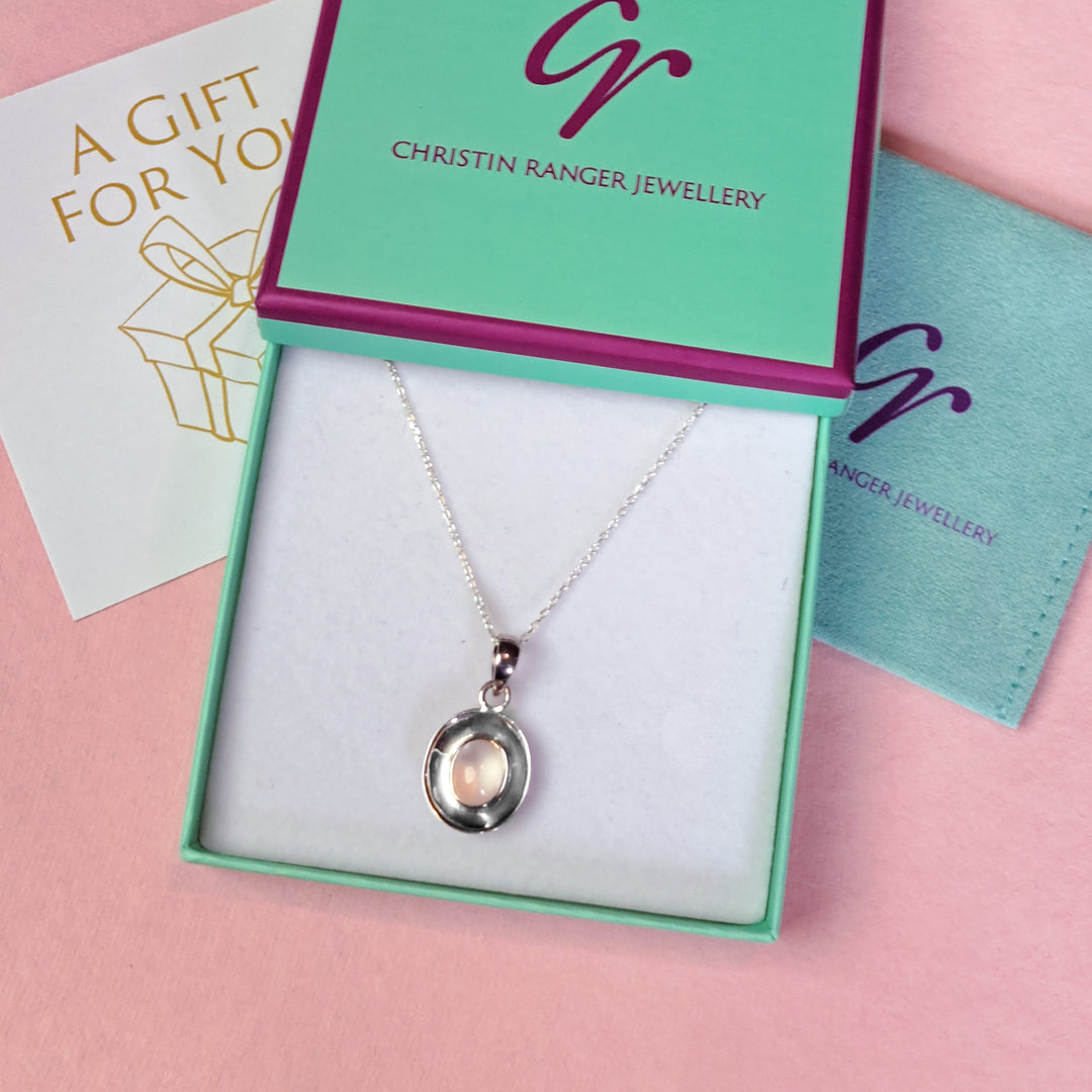 Sterling Silver Dish Shaped Pendant with a rose quartz cabochon gemstone in Christin Ranger Jewellery gift packaging
