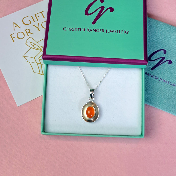 Sterling silver dish pendant with carnelian cabochon gemstone in Christin Ranger Jewellery gift packaging
