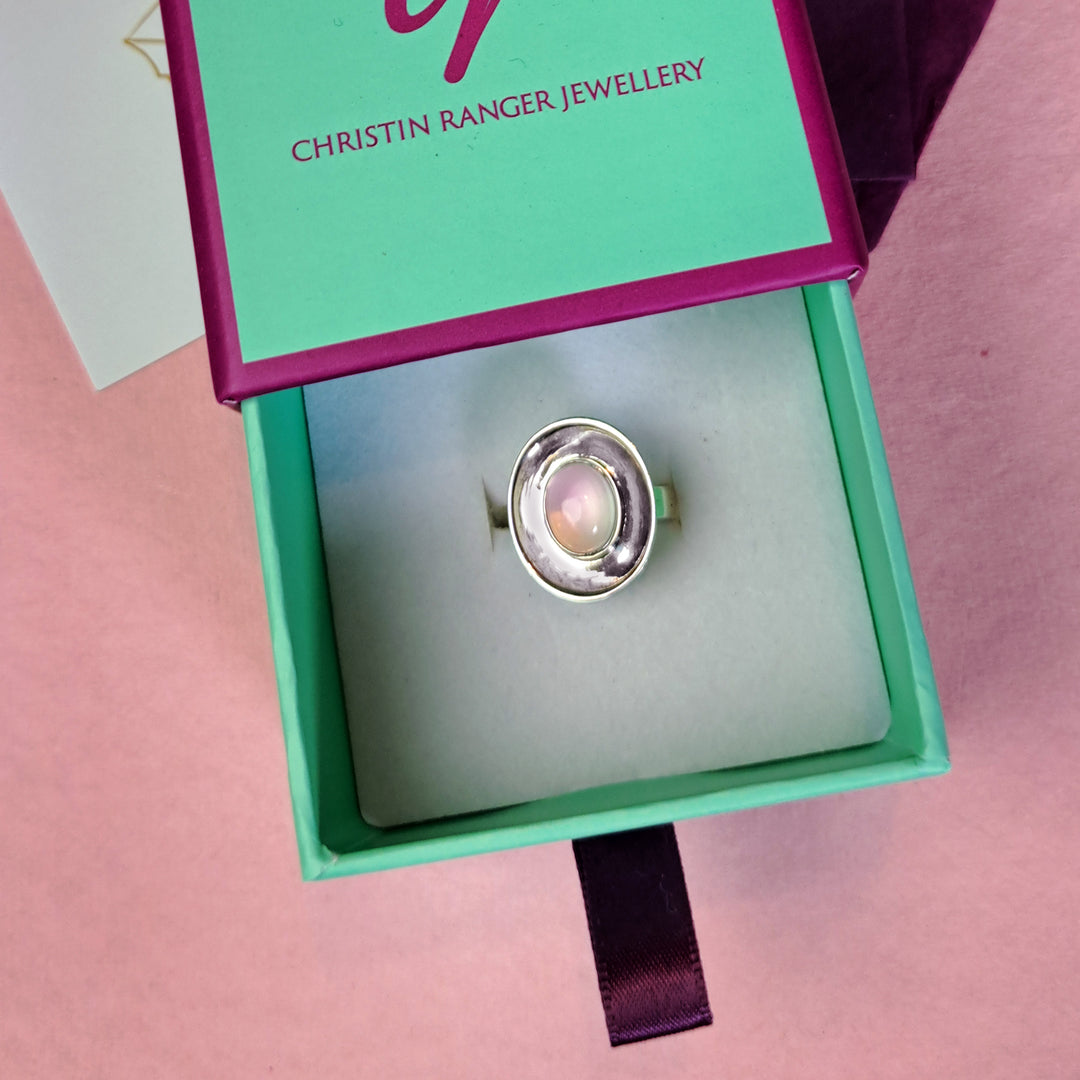 Sterling silver dish shaped ring with rose quartz cabochon gemstone on  Christin Ranger Jewellery gift box.