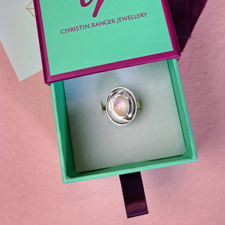 Sterling silver dish shaped ring with rose quartz cabochon gemstone on  Christin Ranger Jewellery gift box.