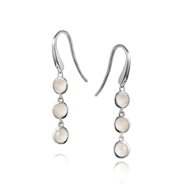 Silver hook earrings with three moonstone drops on a white background
