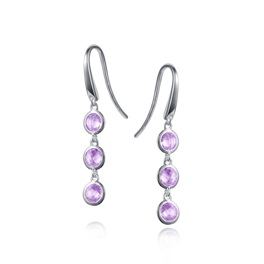 Silver earrings with purple gemstones on a white background