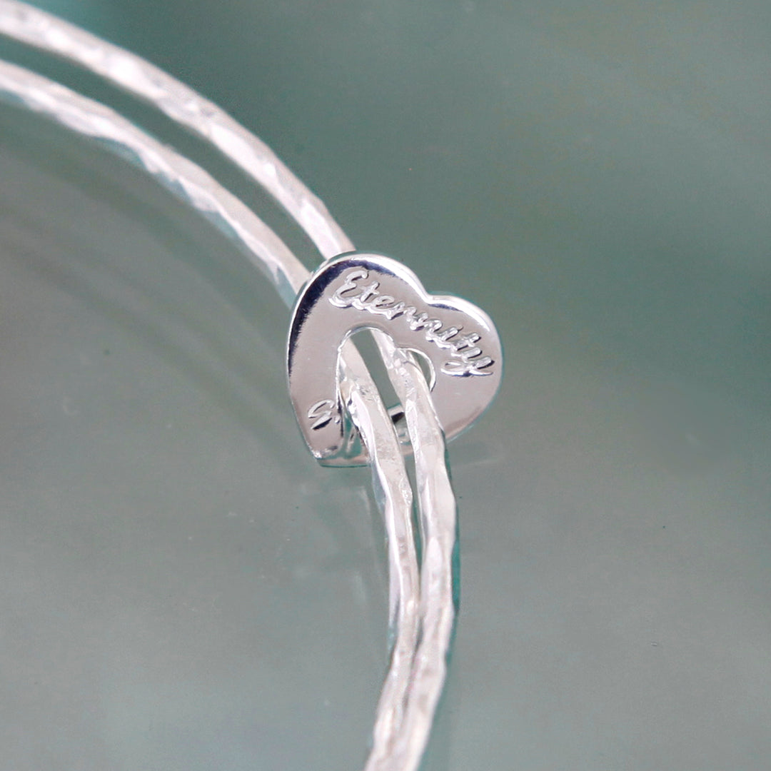 Sterling silver heart eternity double bangle close-up on engraving