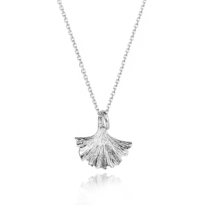 Silver ginkgo leaf pendant on a chain against a white background