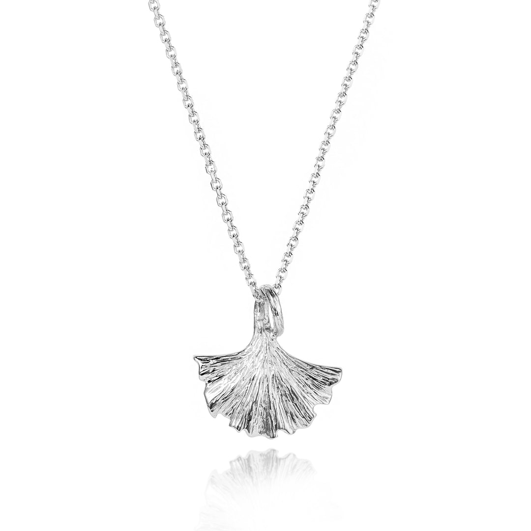 Silver ginkgo leaf pendant on a chain against a white background