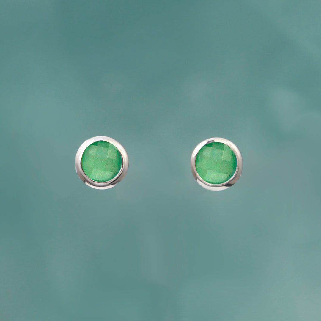green quartz and silver stud earrings on an aqua background