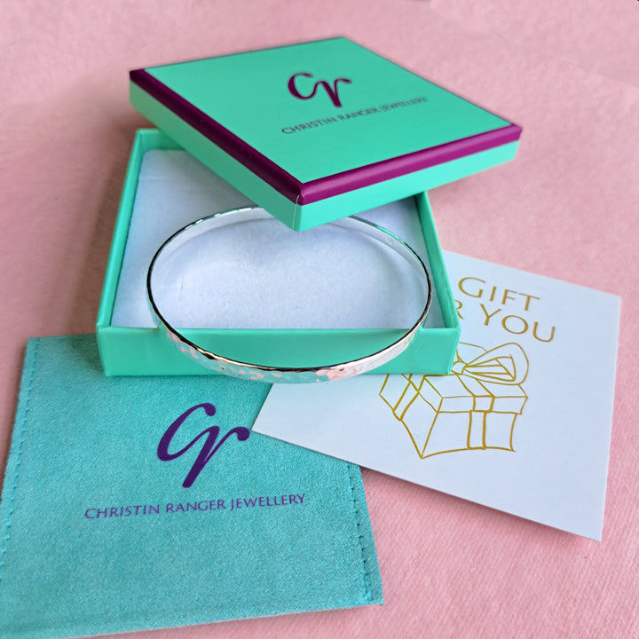 Sterling silver hammered bangle in a Christin Ranger Jewellery gift box with pouch and card