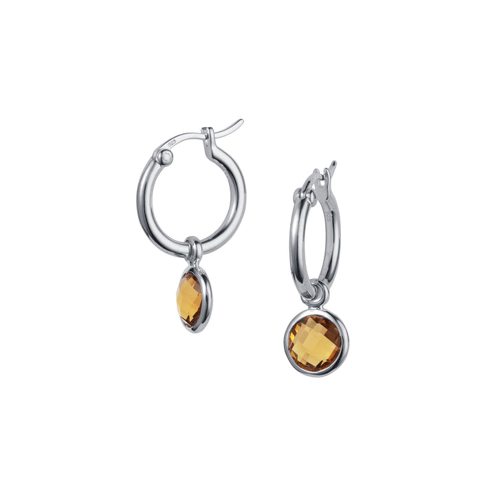 Silver hoop earrings with brown gemstones on a white background