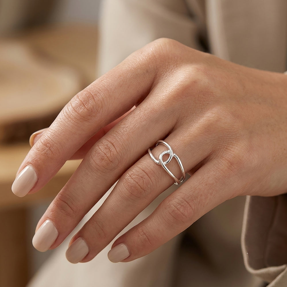 Sterling silver interlocking loop ring on a hand