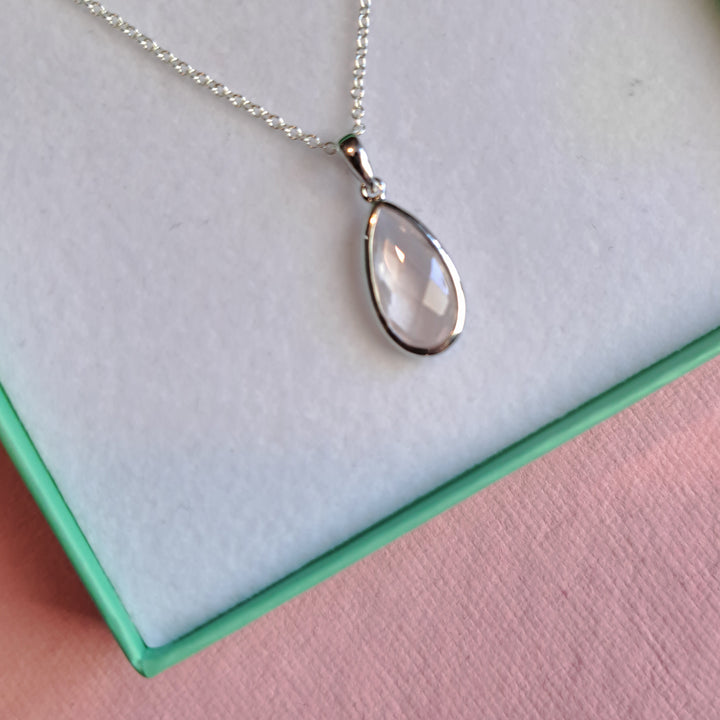 Close-up of sterling silver pear drop pendant necklace with rose quartz