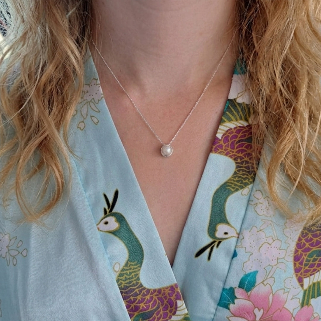 Model wearing a sterling silver pearl pendant necklace
